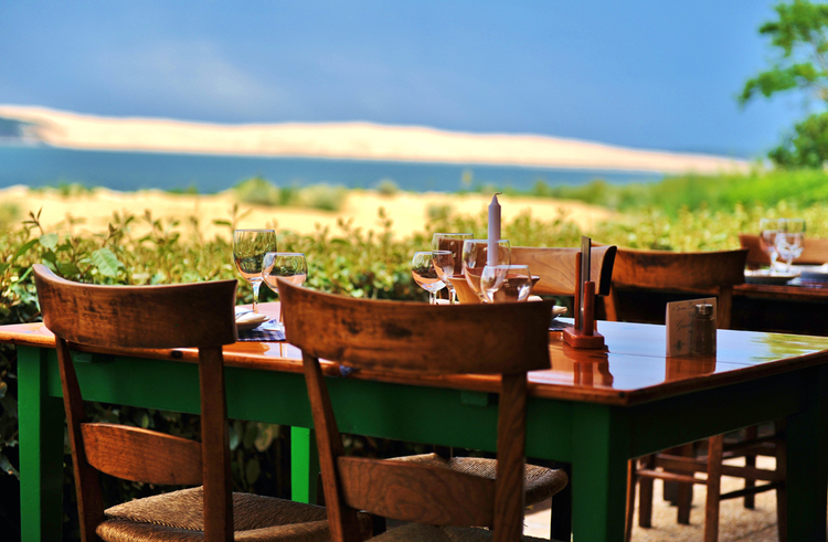 Chez-Hortense restaurant vintage table with four chairs overlooking a picturesque landscape