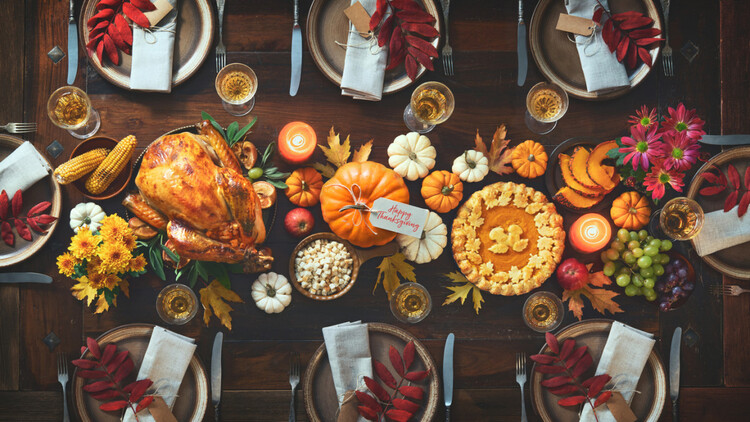 thanksgiving decor a table decorated with different colorful pumpkins fruits flowers and a large turkey in the middle