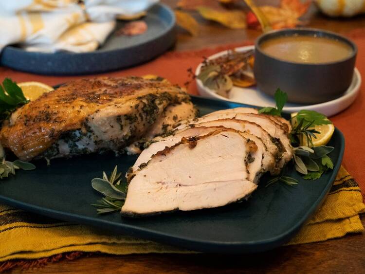 turkey breast served with some gravy and herbs 